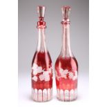 A PAIR OF BOHEMIAN RUBY FLASHED GLASS DECANTERS AND STOPPERS