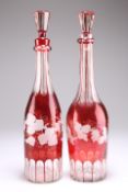 A PAIR OF BOHEMIAN RUBY FLASHED GLASS DECANTERS AND STOPPERS