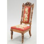 A 19TH CENTURY CARVED WALNUT AND NEEDLEWORK UPHOLSTERED PRIE-DIEU