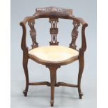 A LATE VICTORIAN CARVED WALNUT CORNER CHAIR