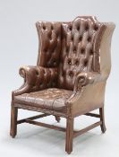 A HANDSOME GEORGE III STYLE DEEP-BUTTONED BROWN LEATHER WING-BACK ARMCHAIR