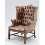 A HANDSOME GEORGE III STYLE DEEP-BUTTONED BROWN LEATHER WING-BACK ARMCHAIR