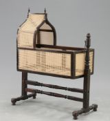 A 19TH CENTURY CANEWORK CRADLE