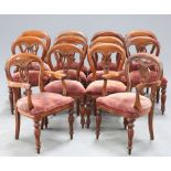 A MAHOGANY WIND OUT DINING TABLE AND TWELVE CHAIRS
