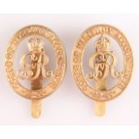 A PAIR OF BRASS CAP BADGES