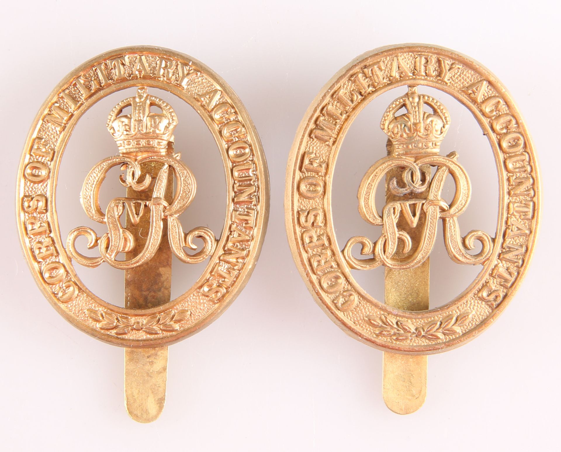 A PAIR OF BRASS CAP BADGES