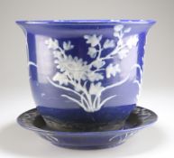 A CHINESE BLUE-GLAZED PORCELAIN JARDINIERE ON STAND