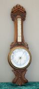 A LATE VICTORIAN OAK ANEROID BAROMETER