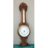 A LATE VICTORIAN OAK ANEROID BAROMETER