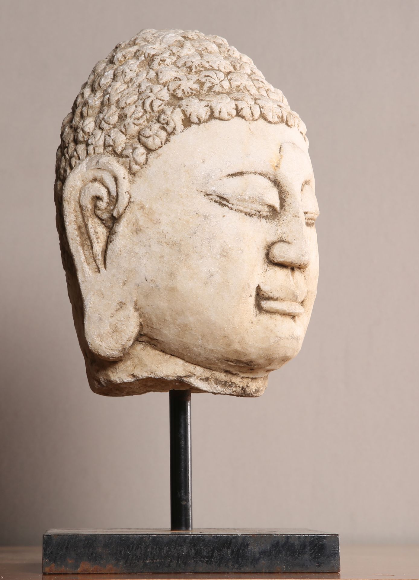 A CHINESE CARVED LIMESTONE HEAD OF BUDDHA - Image 2 of 2