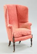 A LATE VICTORIAN MAHOGANY AND UPHOLSTERED WING-BACK ARMCHAIR