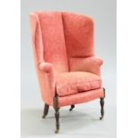 A LATE VICTORIAN MAHOGANY AND UPHOLSTERED WING-BACK ARMCHAIR