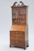 A SMALL GEORGE III STYLE MAHOGANY BUREAU BOOKCASE