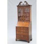 A SMALL GEORGE III STYLE MAHOGANY BUREAU BOOKCASE