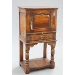 A PERIOD STYLE OAK CUPBOARD ON STAND, PROBABLY BY TITCHMARSH AND GOODWIN