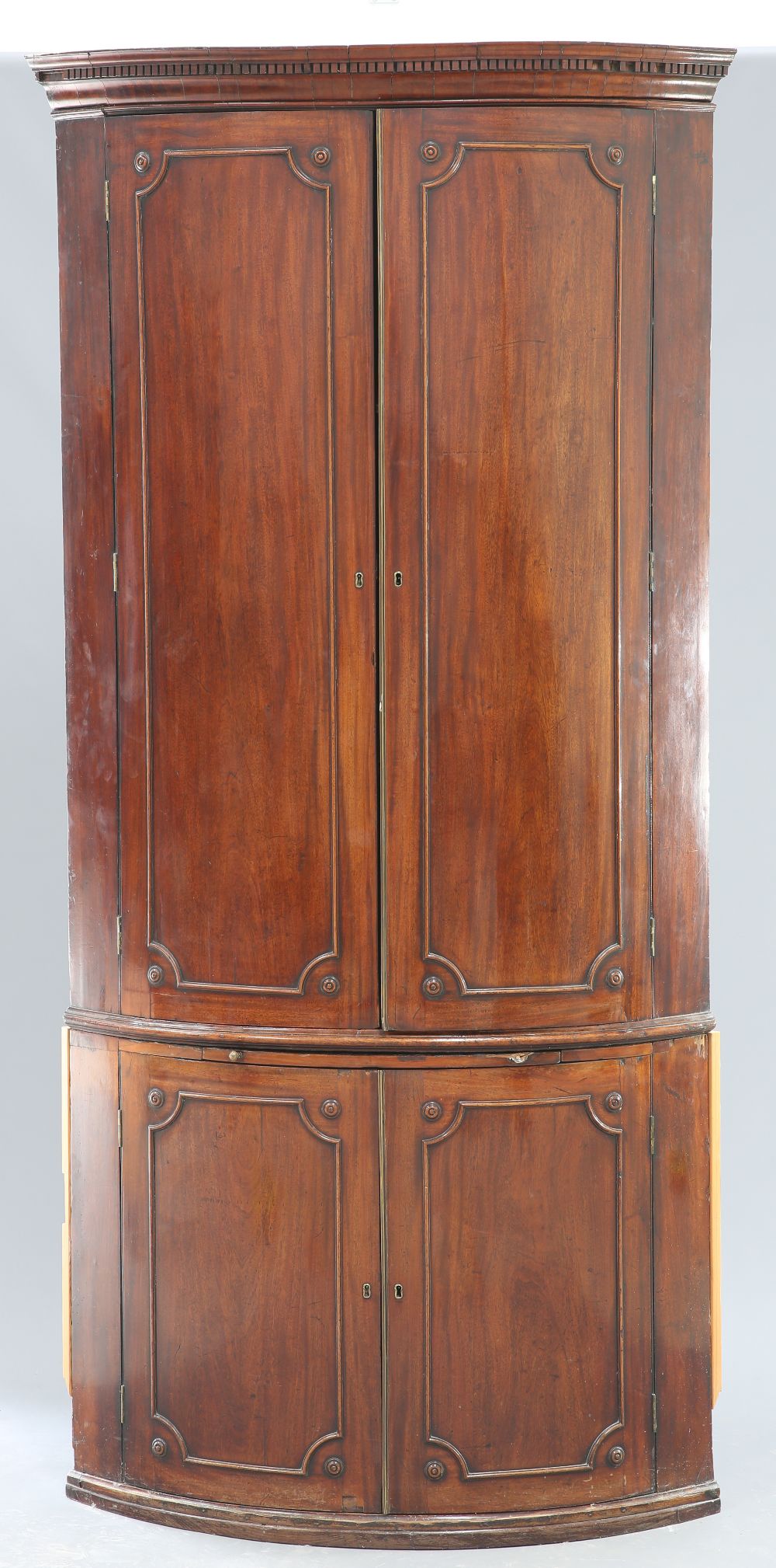 A LARGE GEORGE III MAHOGANY BOW-FRONT DOUBLE CORNER CUPBOARD