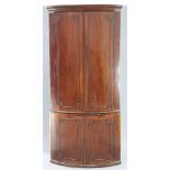 A LARGE GEORGE III MAHOGANY BOW-FRONT DOUBLE CORNER CUPBOARD