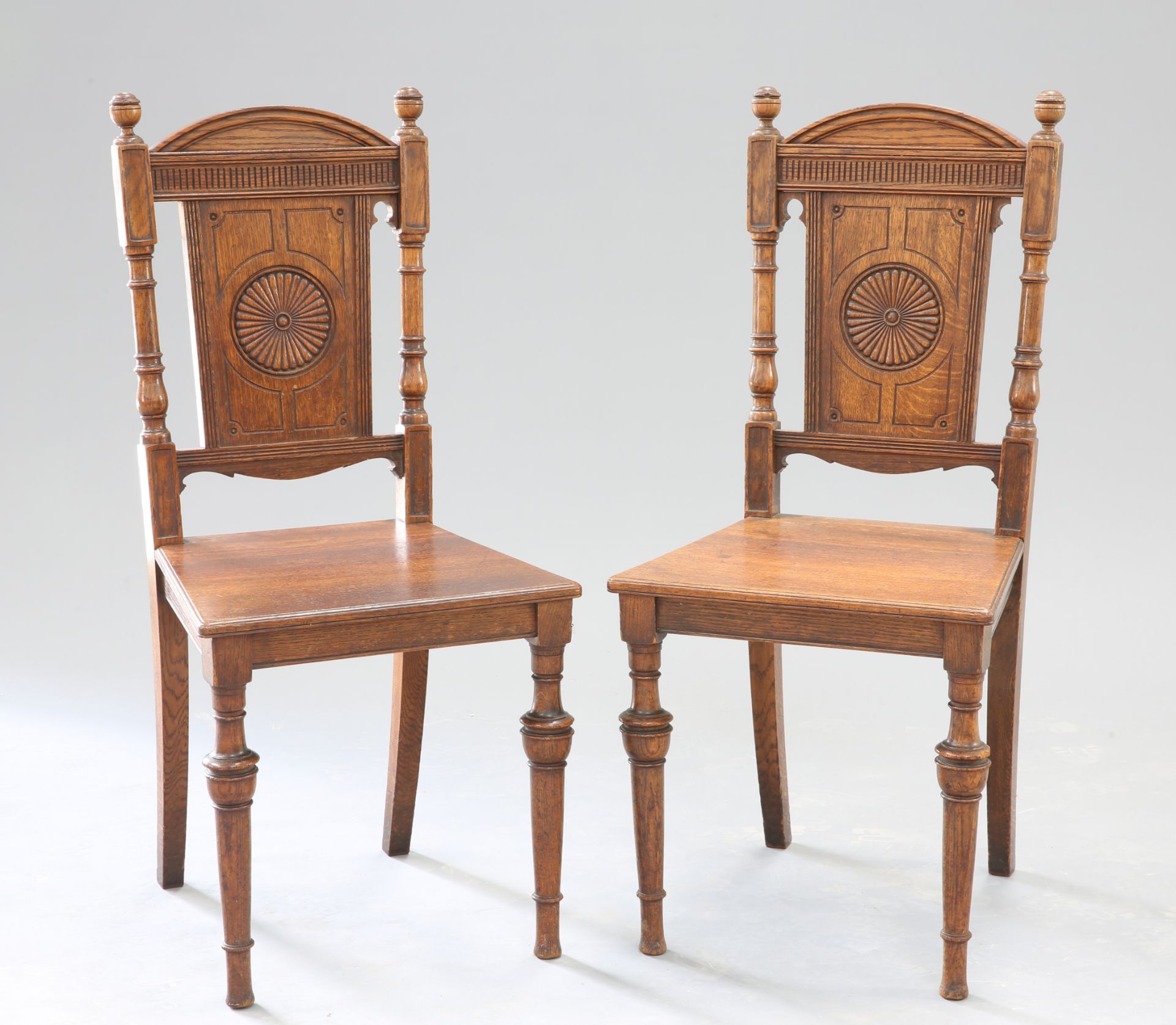 A PAIR OF AESTHETIC MOVEMENT OAK HALL CHAIRS, CIRCA 1880