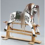 A CARVED AND PAINTED ROCKING HORSE