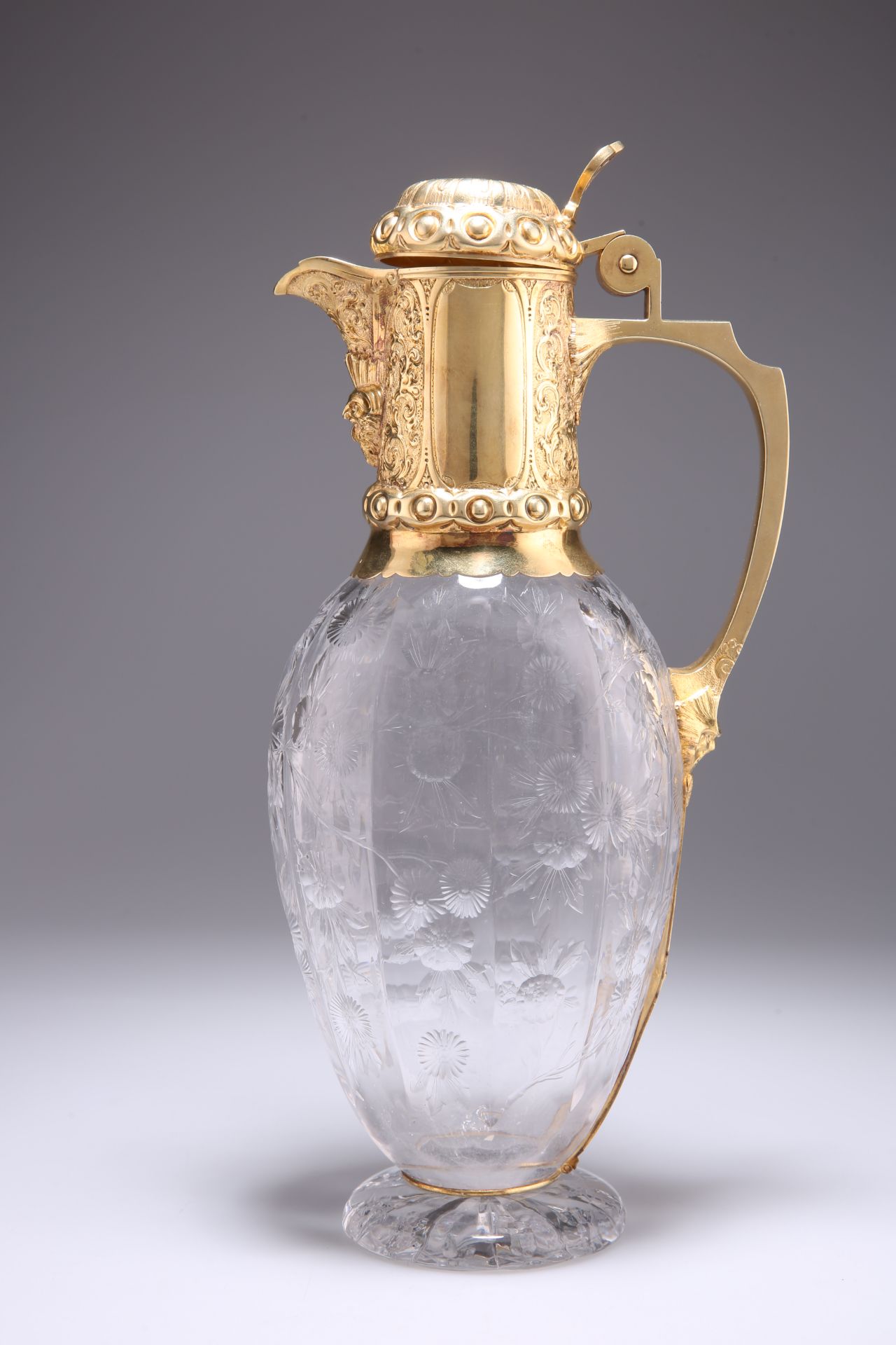 A VICTORIAN SILVER-GILT MOUNTED CUT-GLASS CLARET JUG