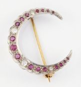 AN 18CT WHITE GOLD RUBY AND DIAMOND CRESCENT BROOCH