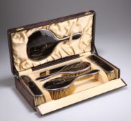 A GEORGE V SILVER-MOUNTED TORTOISESHELL DRESSING TABLE SET