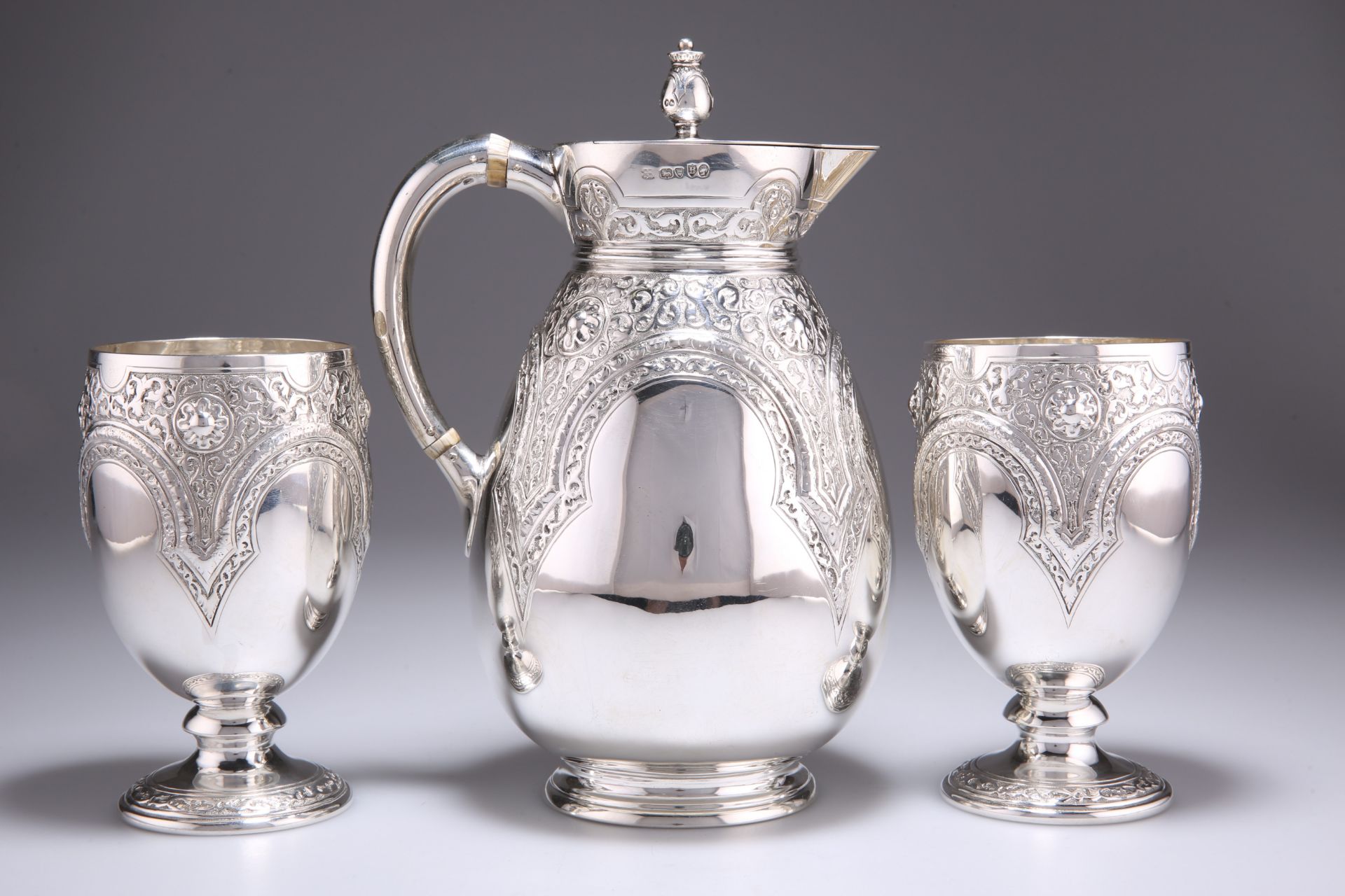 A VICTORIAN SILVER JUG AND PAIR OF GOBLETS