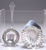 A SILVER TEA STRAINER AND SHELL FORM BUTTER DISH