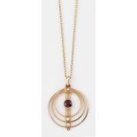 AN EDWARDIAN GARNET AND SEED PEARL PENDANT ON CHAIN