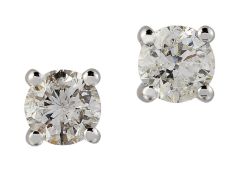 A PAIR OF SOLITAIRE DIAMOND EARRINGS