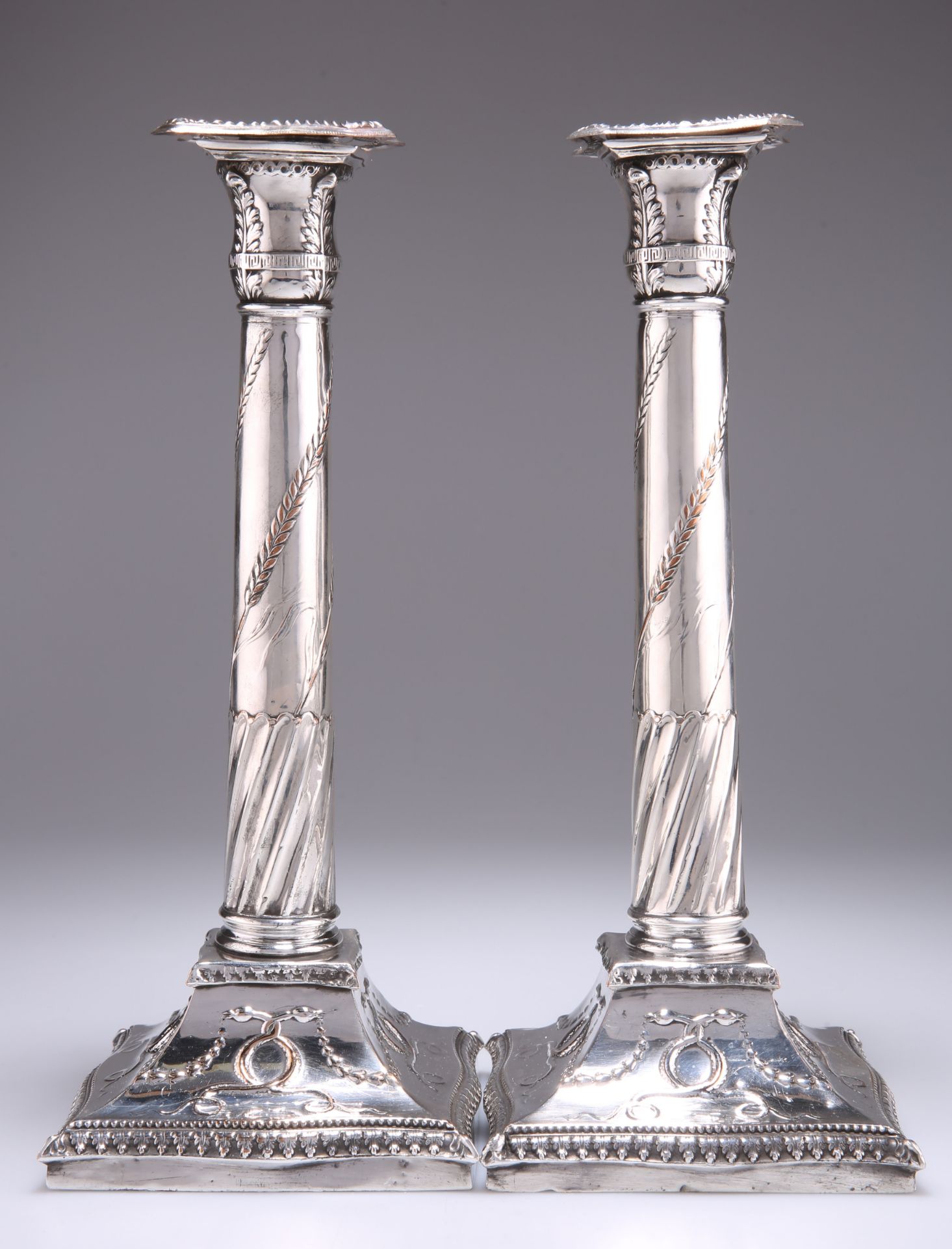 A PAIR OF OLD SHEFFIELD PLATE CANDLESTICKS