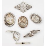 A GROUP OF SEVEN SILVER BROOCHES