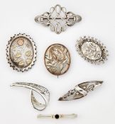 A GROUP OF SEVEN SILVER BROOCHES