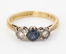 AN 18CT GOLD SAPPHIRE AND DIAMOND THREE STONE RING