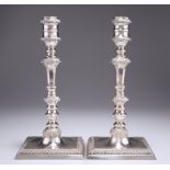 A PAIR OF GEORGE III STYLE CAST SILVER CANDLESTICKS