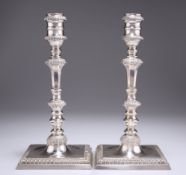 A PAIR OF GEORGE III STYLE CAST SILVER CANDLESTICKS