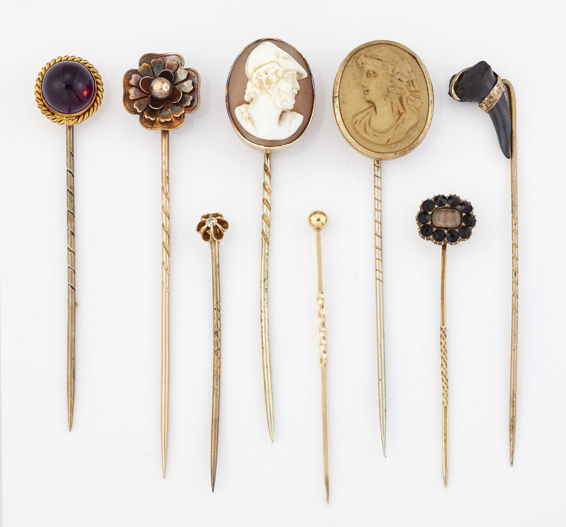 A GROUP OF EIGHT STICK PINS