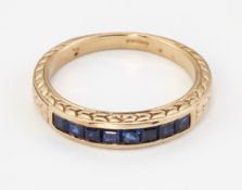 A 9CT GOLD SAPPHIRE HALF HOOP RING