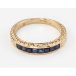 A 9CT GOLD SAPPHIRE HALF HOOP RING