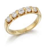 AN 18CT GOLD DIAMOND HALF HOOP RING