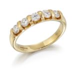 AN 18CT GOLD DIAMOND HALF HOOP RING