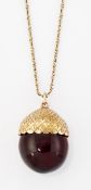 AN AMBER ACORN PENDANT ON CHAIN