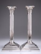 A LARGE PAIR OF EDWARDIAN SILVER COLUMNAR CANDLESTICKS