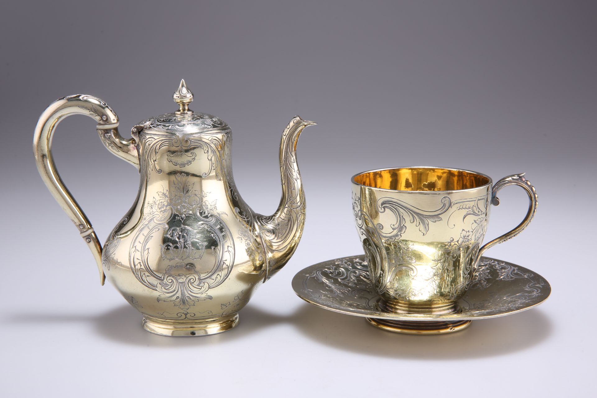 A FRENCH SILVER-GILT COFFEE POT, CUP AND SAUCER, MID 19TH CENTURY