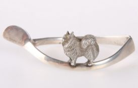 A SILVER NAPKIN CAST WITH ANIMAL