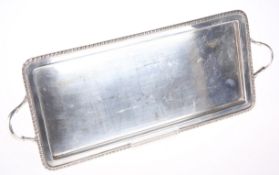 A SILVER-PLATED RECTANGULAR TWO HANDLED TRAY