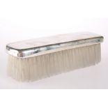 A SILVER-PLATED MOUNTED CLOTHES BRUSH
