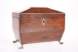 A 19TH CENTURY FIGURED MAHOGANY SARCOPHAGUS TWO DIVISION TEA CADDY