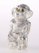 A SILVER-PLATED PIN CUSHION IN THE FORM OF A MONKEY