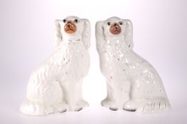 A PAIR OF VICTORIAN STAFFORDSHIRE POTTERY MANTEL DOGS